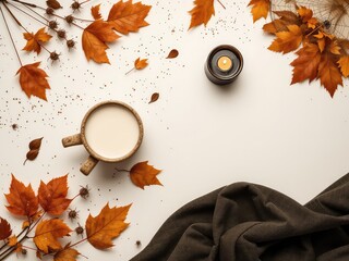Autumnal scene featuring warm toned leaves, a lit candle, comforting drink, and soft fabric on a light surface