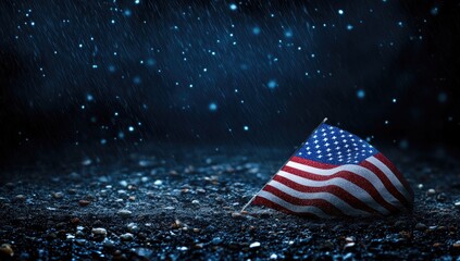 American flag on dark ground, rainy night