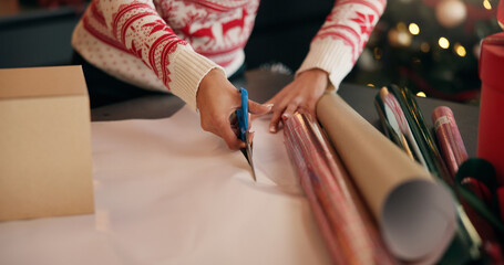 Hands, cut and woman with wrapping paper for.christmas gifts, holiday tradition and celebration. Preparation, person and packaging box in house for surprise present, festive season and party event