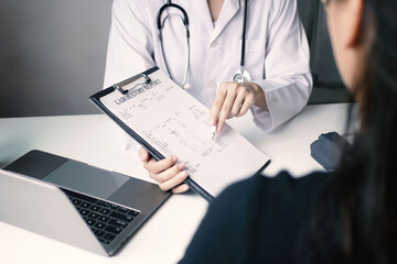 An Asian female doctor made an appointment for a patient to hear the results of the examination and explained the results in detail with the results of the examination and treatment in the hospital