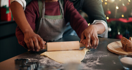Baking, Christmas and hands of child with parent in kitchen of home for festive tradition or help. Holidays, learning and rolling pin with family at apartment together for cooking in December season