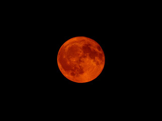 A large red moon is in the sky