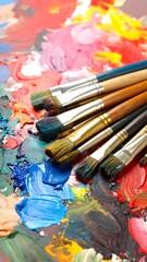 Obraz premium Paintbrushes on a vibrant artist's palette