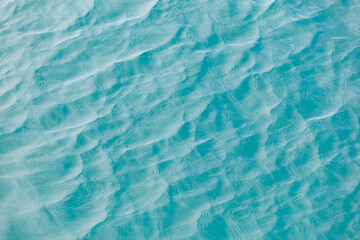 Fototapeta premium The image is of a body of water with ripples and waves