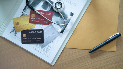 Multiple credit cards on medical documents with stethoscope, representing various payment options.