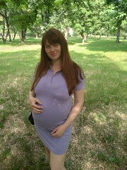 Stock photo of a pregnant woman in the park