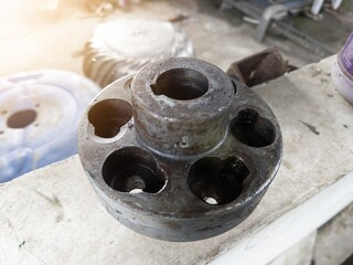 Close up an worn or damaged motor pump rotation connection flange.