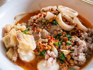Tom Yum Seafood Noodles with Crispy Pork Cracklings or Pork Rinds.