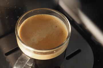 Freshly brewed coffee in a clear glass cup