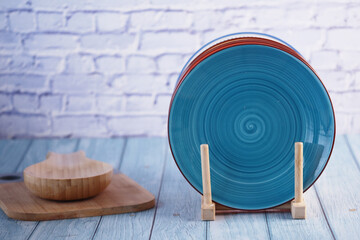 Colorful decorative plates displayed on a wooden table