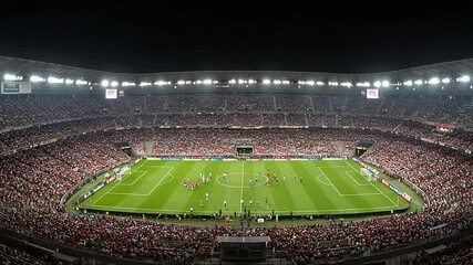 Exciting soccer match in a packed stadium at night (1) - Powered by Adobe