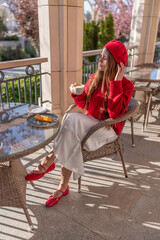 Woman Coffee Beret: Sunny morning, stylish woman enjoys coffee & pastry on cafe patio.