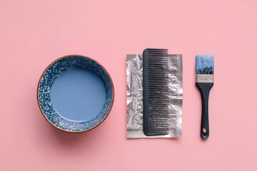 Flatlay of hair dye bowl, comb, foil, and brush on pink background.  Lavender dye is visible in the bowl.  Tools are neatly arranged for at-home hair coloring