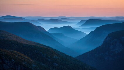 Misty, layered mountains at dawn, showcasing a serene, cool-toned palette of blues and purples, with a hazy, atmospheric perspective