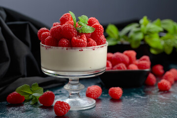 Mascarpone cream with fresh raspberries in a clear bowl.