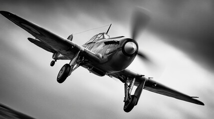 A vintage propeller plane in flight, captured in a dramatic black and white image, showcasing its powerful engine and elegant design against a cloudy sky