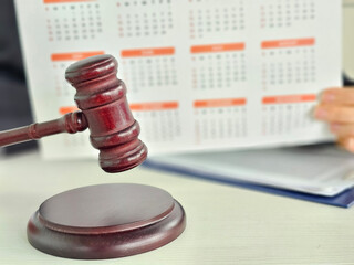 Courtroom gavel stands in front of calendar showing important legal dates and deadlines