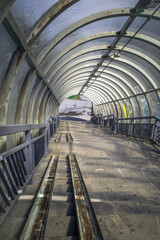 An empty staircase of an above-ground pedestrian crossing on a summer day