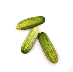 Fresh Organic Cucumbers Isolated on White Background. Group of Green Cucumbers on Clean White Surface. Healthy Green Cucumbers for Diet and Nutrition Design. Top View high resolution image.