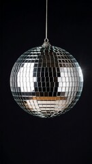Shiny disco ball against black backdrop