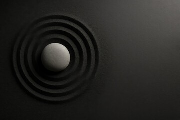Single stone highlighted by angled beam of light on textured surface — concept of focus, awareness, and clarity