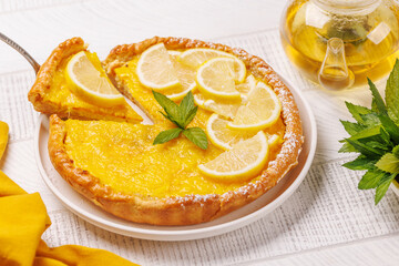 Delicious lemon tart with golden crust and smooth, glossy lemon filling
