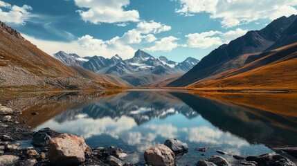 Tranquil small lake nestled among majestic mountain peaks under a clear blue sky, serene natural landscape ideal for outdoor travel, nature retreat, and wilderness exploration concepts






