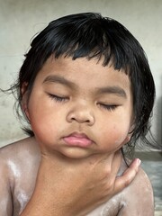 Close up portrait of little Asian girl sleeping