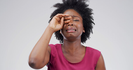 Black woman, crying and sad in studio with depression, grief or loss with emotion on white...