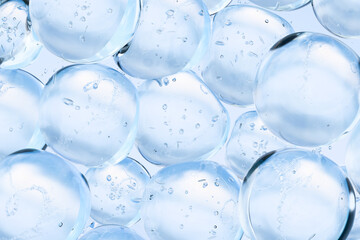 Transparent blue water bubbles floating in clear liquid. Abstract 3D background symbolizing purity,...