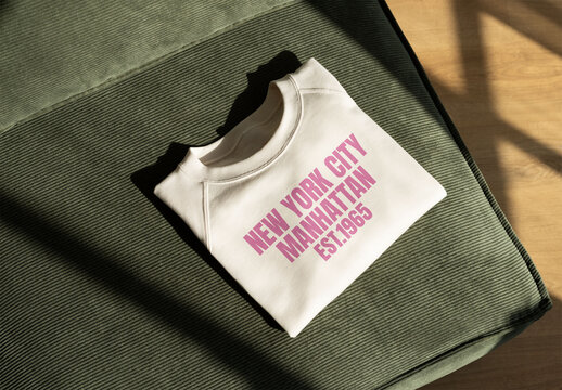 Modern Mockup of Folded sweatshirt on Textured green sofa