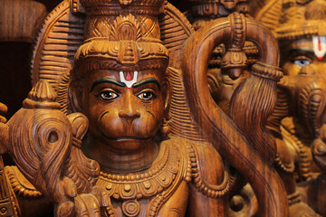 Hanuman wooden carving statue, Hindu monkey god from Ramayana epic, traditional Indian sculpture, deity of strength and devotion, religious art