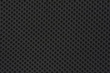 A macro shot captures the uniform, perforated texture of black mesh fabric