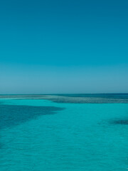 Calm turquoise water meeting blue sky on the horizon, tropical paradise seascape