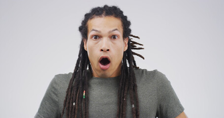 Surprise, portrait and shocked man in studio with face expression, bad news or announcement....