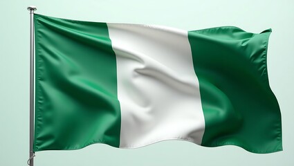 The flag of Nigeria waving, featuring green and white vertical stripes on a pole.