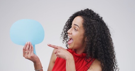 Pointing, speech bubble and woman in studio, excited and announcement on white background. Person, social media and chatting poster with gesture, communication and opportunity with voice review