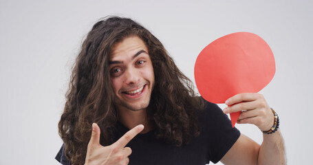 Blank sign, pointing and portrait of man in studio with feedback, announcement or vote. Social...
