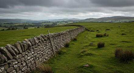 Stone Wall in Green Countryside Under Cloudy Sky