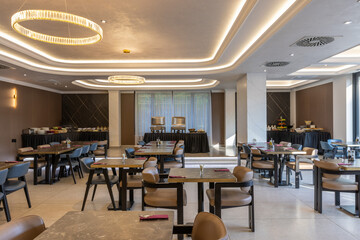 Interior of a modern hotel restaurant with ceiling lighting