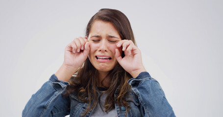 Sad, crying and woman with depression in studio with stress for broken heart or fail on white...