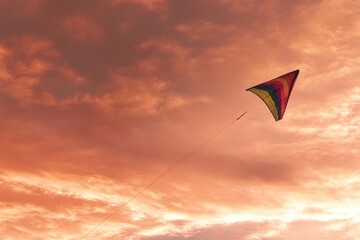 Solitary kite against dramatic sunset sky, minimalistic aesthetic for serene designs
