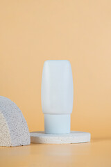 Plastic white tube for cream or lotion. Skin care or sunscreen cosmetic with stylish props on cream...