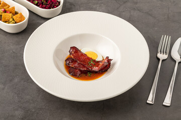 Barbecue pork slices with hard-boiled egg in a savory brown sauce