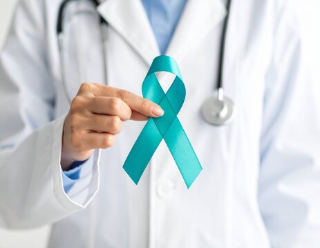 doctor's hand holding teal ribbon support ovarian cancer awareness