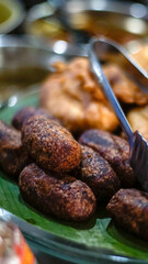 Timus, traditional Indonesian deep-fried sweet potato snack served on a banana leaf. Popular as a traditional dessert or street food in Java.