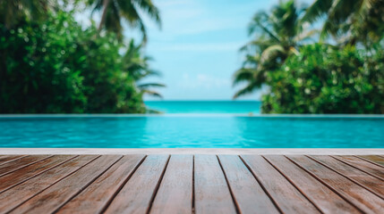 A tranquil infinity pool overlooking a tropical beach framed by lush palm trees under a clear blue sky.