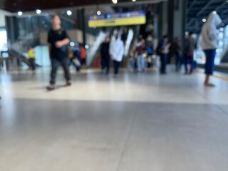 Jakarta, June 20, 2025. Background of the area inside the station with the ticket counter, the station entrance gate and the public in the background. Blurred