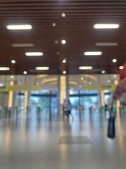 Jakarta, June 20, 2025. Background of the area inside the station with the ticket counter, the station entrance gate and the public in the background. Blurred