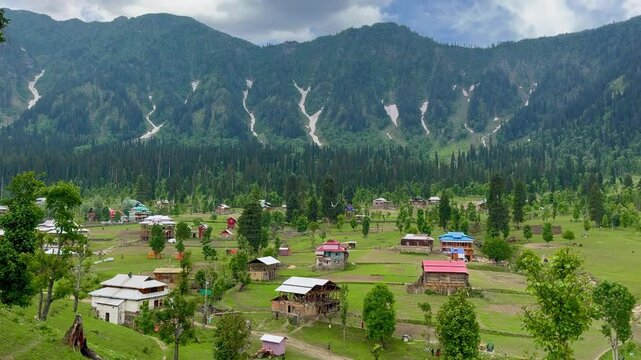 A breathtaking view of traditional wooden houses nestled in the scenic village of Arang Kel, Azad Kashmir.
